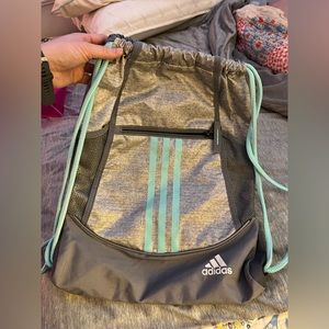 two drawstring bags one is Adidas the other is athleta girl